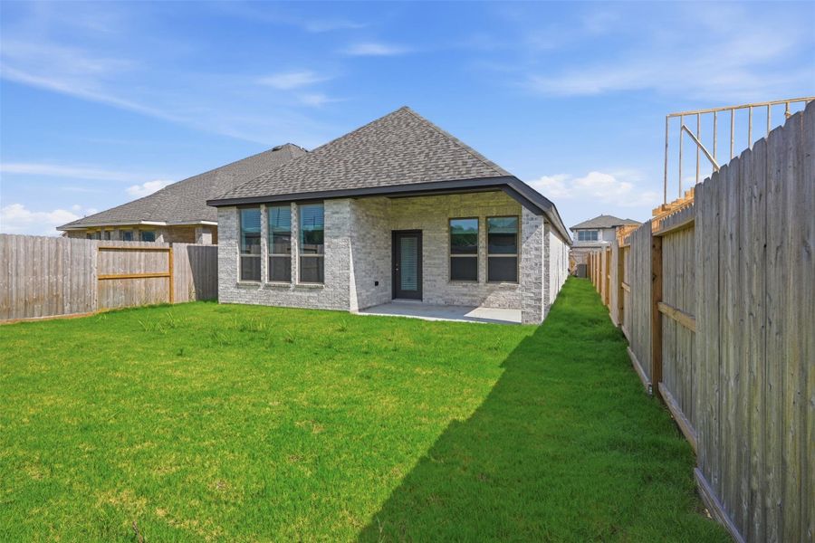 Charming single-story home with a spacious fenced backyard, featuring a well-maintained lawn and modern exterior. Ideal for outdoor activities and relaxation.