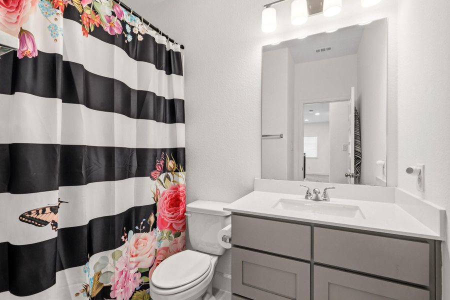 Additional full bathroom featuring a functional layout and contemporary design