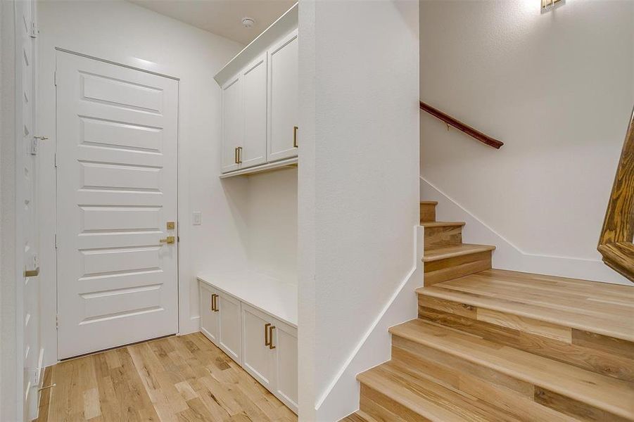 Mudroom with light hardwood / wood-style floors