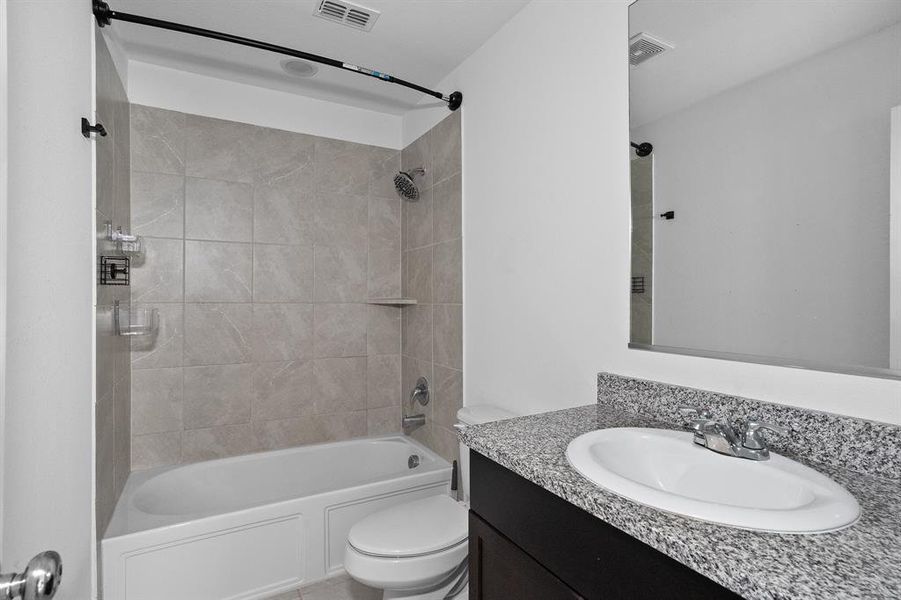 Full bathroom with bathing tub / shower combination and vanity