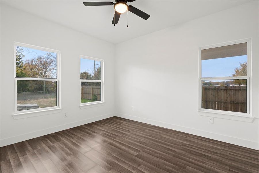 Spare room with dark hardwood / wood-style floors and ceiling fan