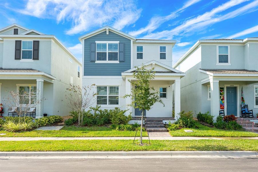 Front exterior of a new home in Osprey Ranch, Winter Garden, FL, highlighting curb appeal (Image 21). Front exterior of a new home in Osprey Ranch, Winter Garden, FL, highlighting curb appeal (Image 21).