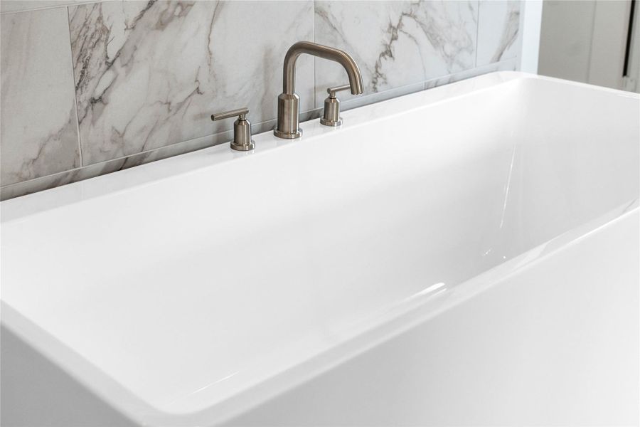 Unwind after a long day in the deep, corner soaking tub, a perfect sanctuary for relaxation. The tub is accented by stylish fixtures.