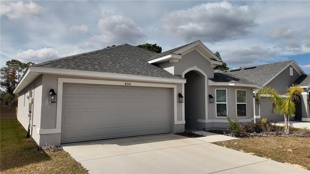 Front exterior of a new home in Pine Bluff, Spring Hill, FL, highlighting curb appeal (Image 20).