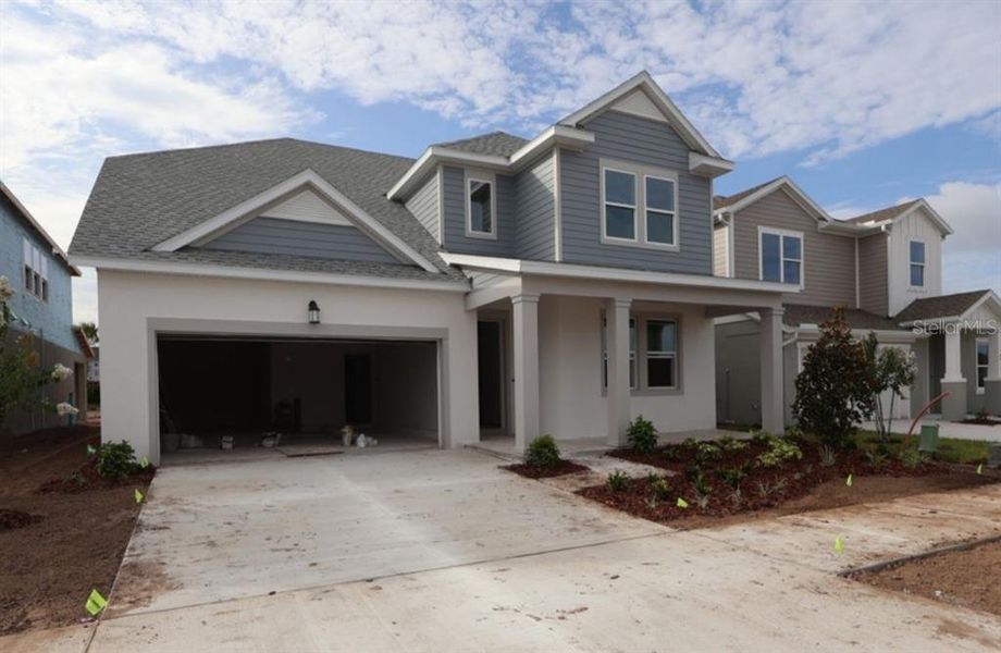 Front exterior of a new home in Waterset Classic Series, Apollo Beach, FL, highlighting curb appeal (Image 2). Front exterior of a new home in Waterset Classic Series, Apollo Beach, FL, highlighting curb appeal (Image 2).