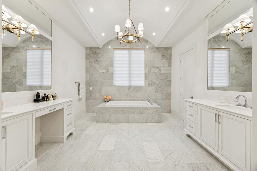 Primary bath with barrel ceiling, marble accents and dual vanity areas
