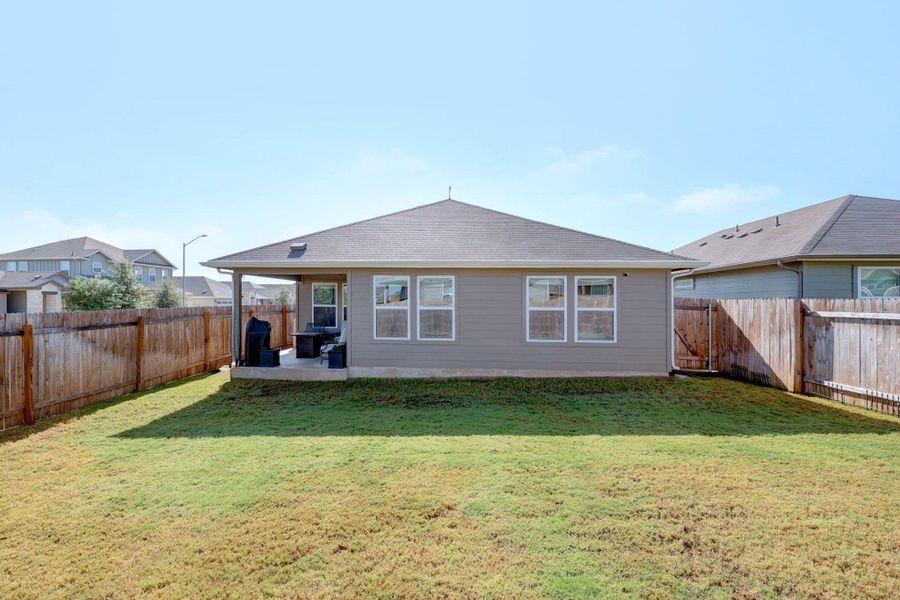 Rear view of house with a patio and a fenced backyard Rear view of house with a patio and a fenced backyard
