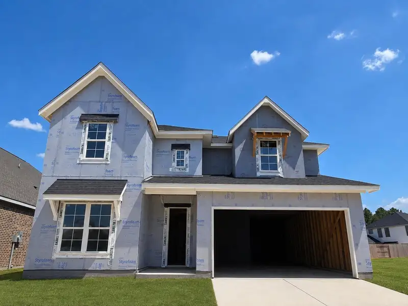 Front exterior of a new home in , Porter, TX, highlighting curb appeal (Image 1). Front exterior of a new home in , Porter, TX, highlighting curb appeal (Image 1).