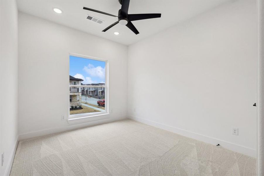 Spare room with light carpet and ceiling fan