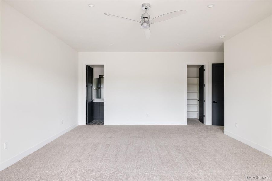 Expansive lower-level bedroom has a walk-in closet and ensuite bath, space for a table and chairs