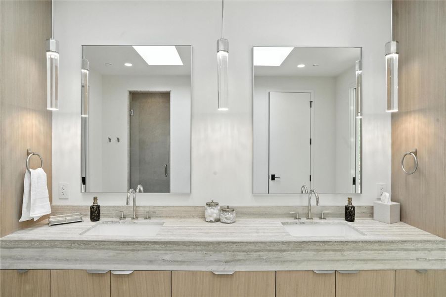 Bathroom with a skylight, double vanity, and recessed lighting Bathroom with a skylight, double vanity, and recessed lighting