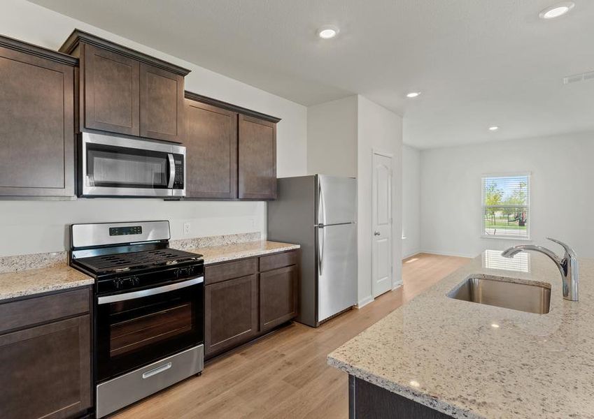 The kitchen has gorgeous wood cabinetry.