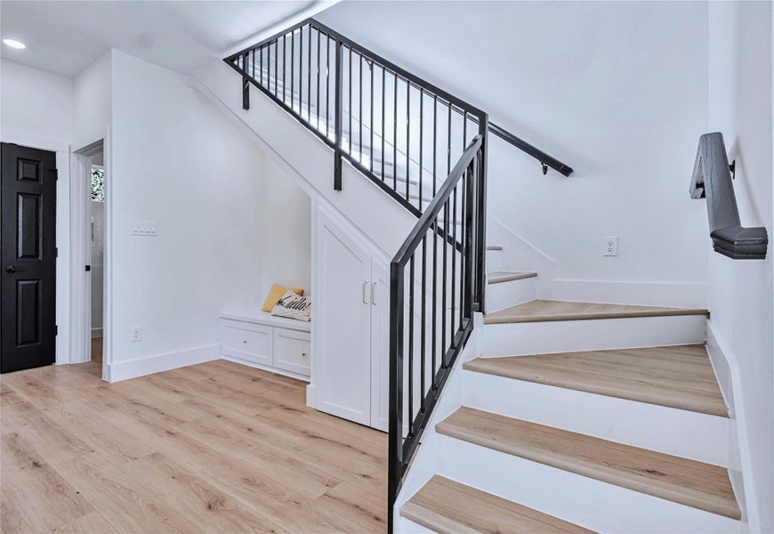 Staircase featuring recessed lighting, baseboards, and wood finished floors