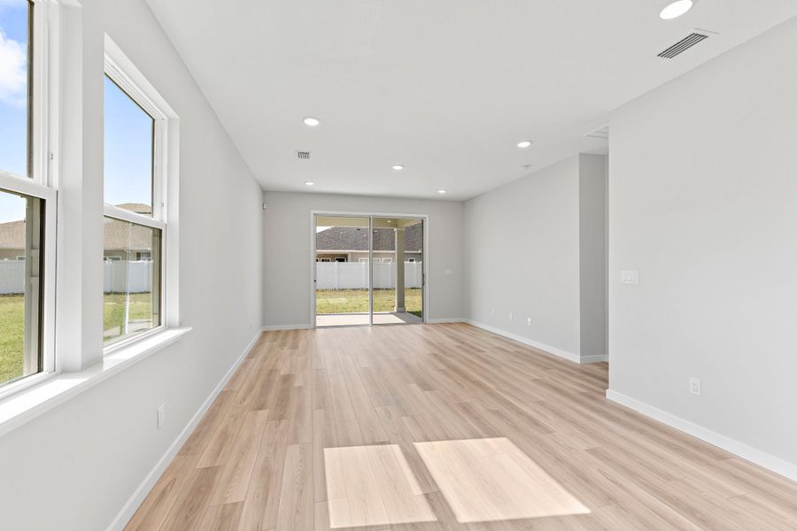 Open Dining Area with Light LVP Flooring in Lot 19 Cedar II at Camden Woods in Kingsland, GA