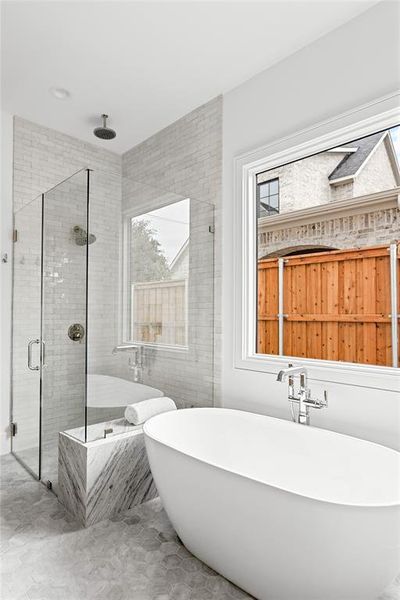Full bathroom featuring a freestanding bath and a stall shower