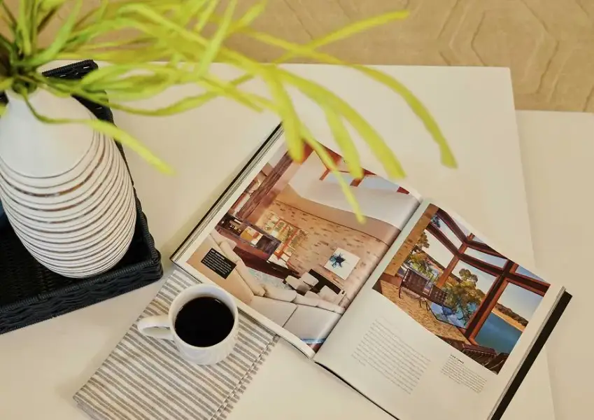 Living room with coffee table, cup of coffee, and open book. Living room with coffee table, cup of coffee, and open book.