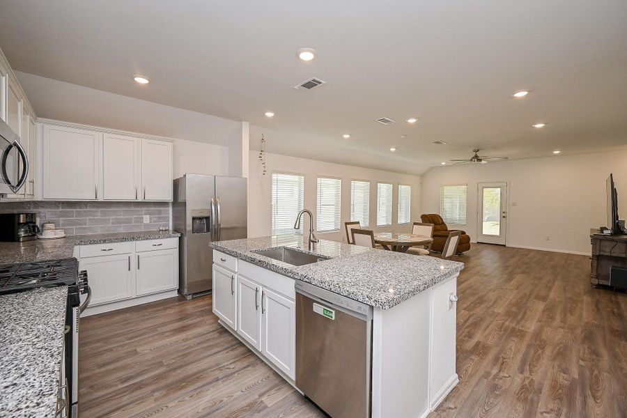 White cabinetry, Granite countertops, Central island, Light gray subway tile backsplash. White cabinetry, Granite countertops, Central island, Light gray subway tile backsplash.