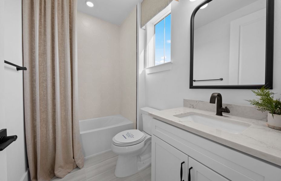 Representative furnished interior of a home built from the Layton Grande by DiVosta in BeachWalk by Manasota Key, Englewood (Image 28).