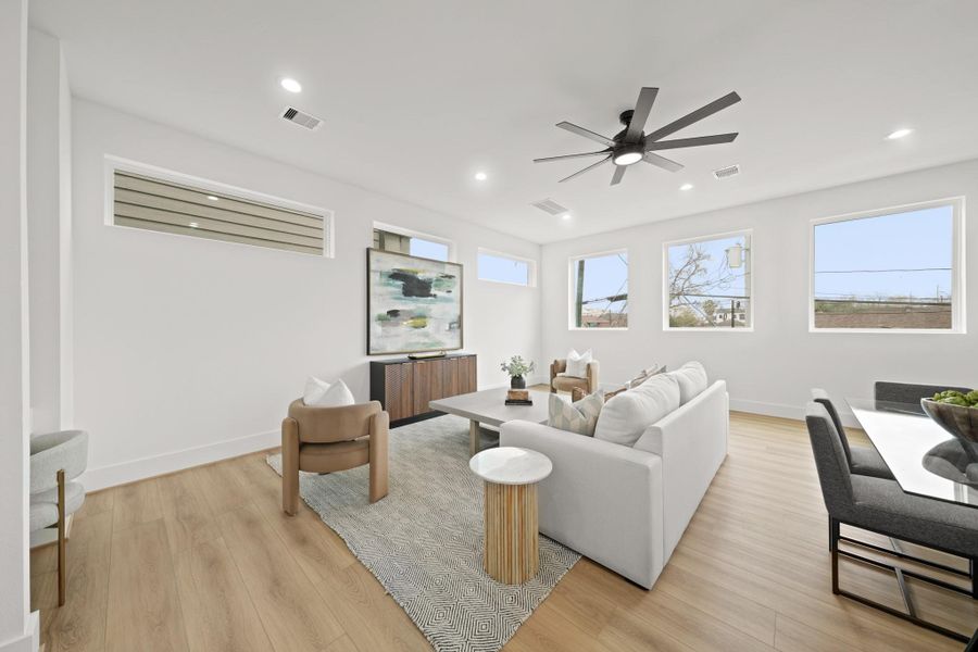 With white oak luxury vinyl plank flooring throughout, the rooms flow seamlessly from the spaciously designed family room to the formal dining.