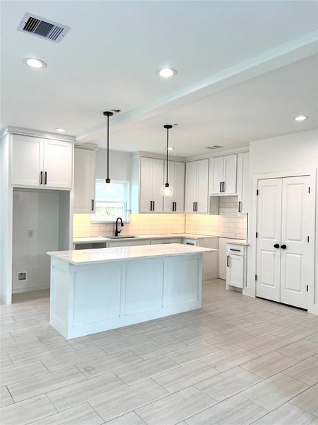 Stylish floor-to-ceiling cabinetry enhances storage efficiency.