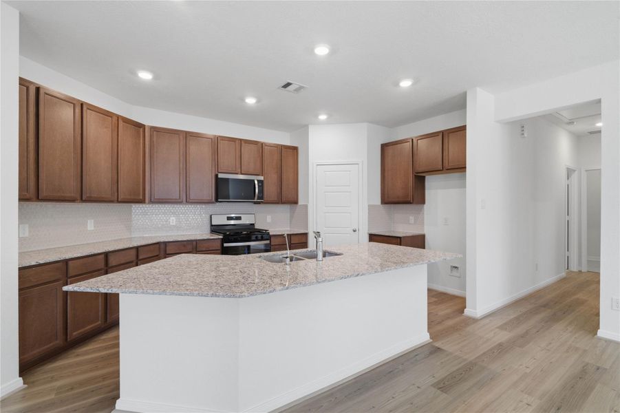 This expansive kitchen island acts as the ultimate hub for daily life—offering plenty of room for holiday food prep, casual dining, and hanging out while the chef cooks. This expansive kitchen island acts as the ultimate hub for daily life—offering plenty of room for holiday food prep, casual dining, and hanging out while the chef cooks.
