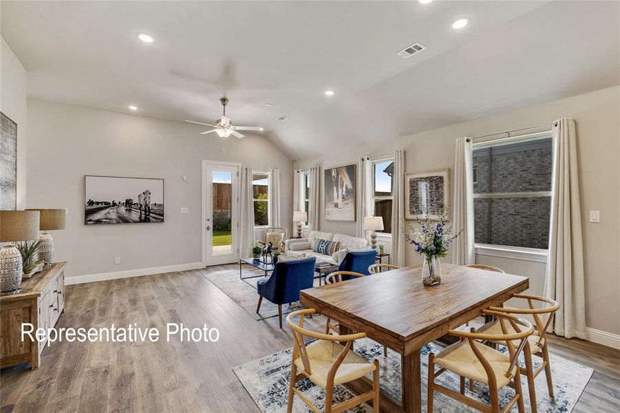 Dining space featuring light wood-type flooring, lofted ceiling, and ceiling fan