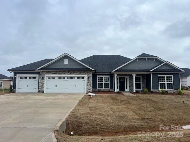 Front exterior of a new home in Swann Hills, Statesville, NC, highlighting curb appeal (Image 2). Front exterior of a new home in Swann Hills, Statesville, NC, highlighting curb appeal (Image 2).