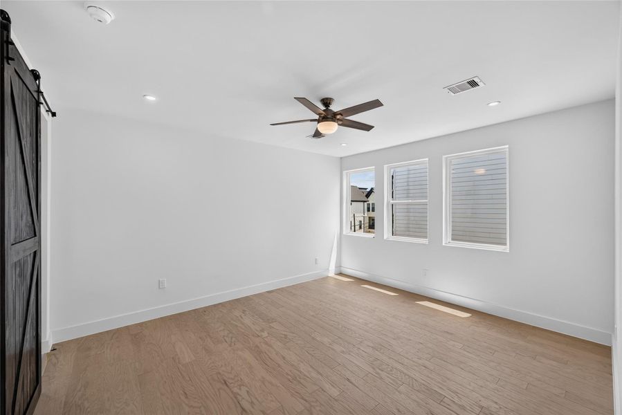 Primary bedroom featuring a custom sliding barn door