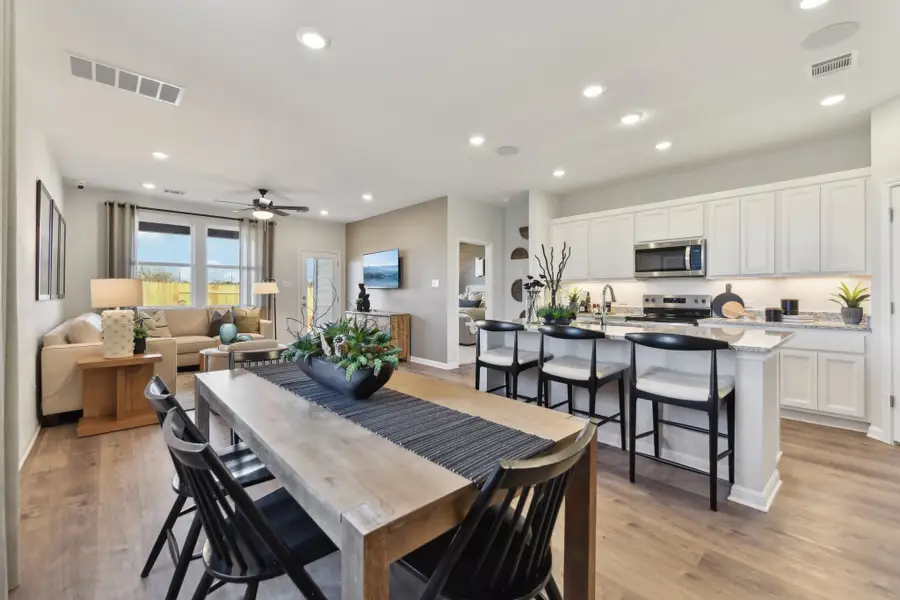 A kitchen with a dining table and chairs. A kitchen with a dining table and chairs.
