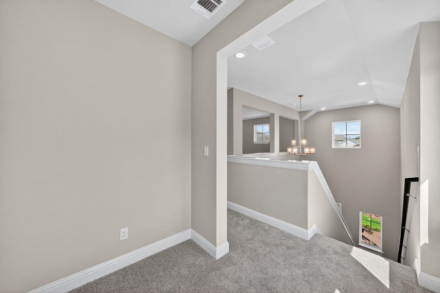 Unfurnished room featuring carpet, recessed lighting, a chandelier, and lofted ceiling Unfurnished room featuring carpet, recessed lighting, a chandelier, and lofted ceiling