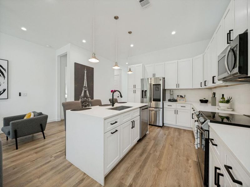 Culinary delights await in this bright kitchen, complete with an island sink and a suite of stainless steel appliances. Culinary delights await in this bright kitchen, complete with an island sink and a suite of stainless steel appliances.