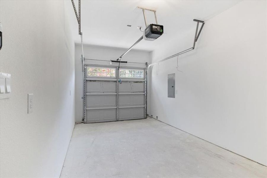 Garage featuring a garage door opener