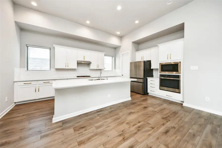 Open-concept kitchen with large island and adjacent dining area