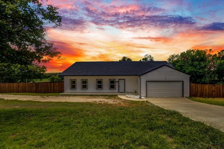 Modern ranch-style home featuring a dark shingle roof, light-colored siding, and a single-car garage