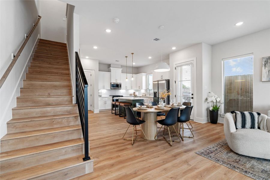 Defined by its open iron railing, the staircase serves as both a functional feature and a subtle architectural statement.