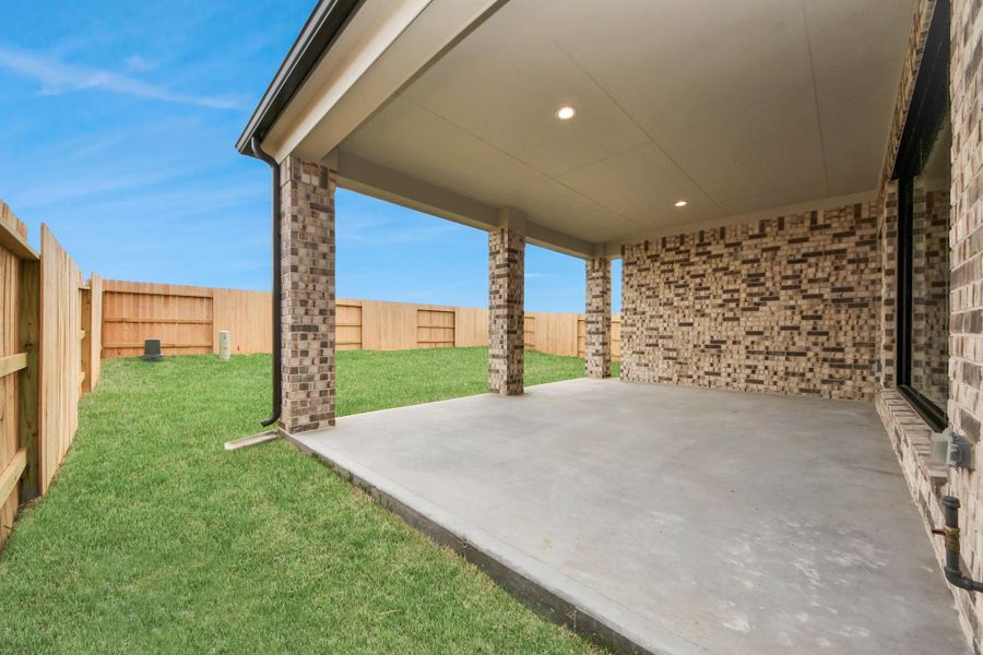 Experience outdoor living at its finest on this expansive covered patio, thoughtfully designed for BBQs and delightful outdoor dining.
