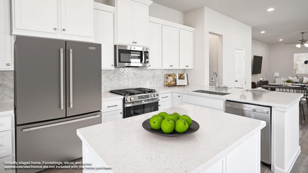 Kitchen featuring stainless steel appliances, white cabinetry, a peninsula, backsplash, and recessed lighting