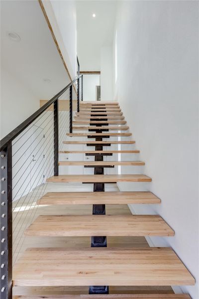 Stairway featuring wood finished floors Stairway featuring wood finished floors