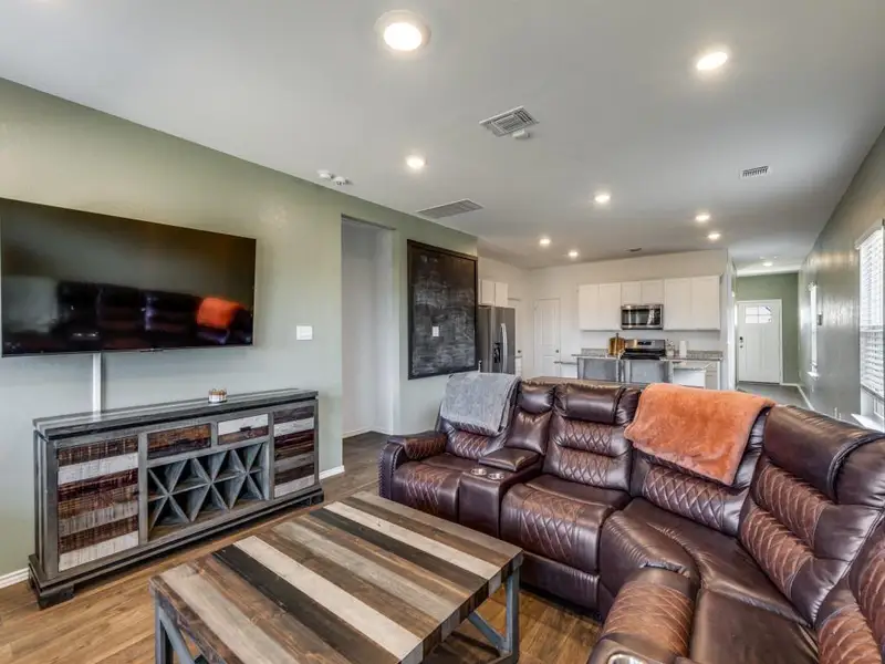 Living area featuring recessed lighting and dark wood-style floors