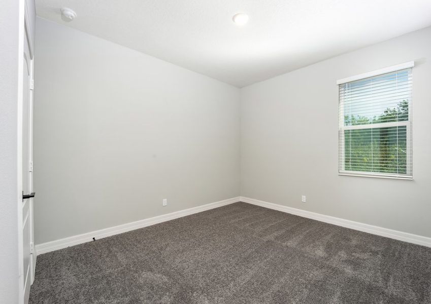 The spare bedroom is spacious with a large window