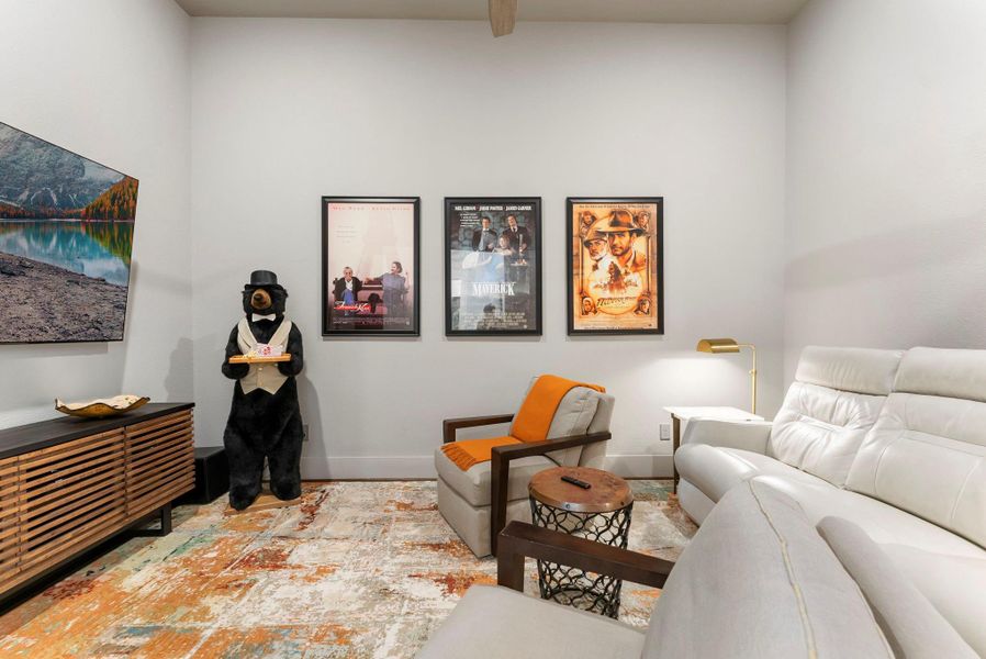 A second view of the media room highlights its comfortable scale and separation from the main gathering spaces. The room adds lifestyle flexibility without requiring stairs or sacrificing bedroom count.