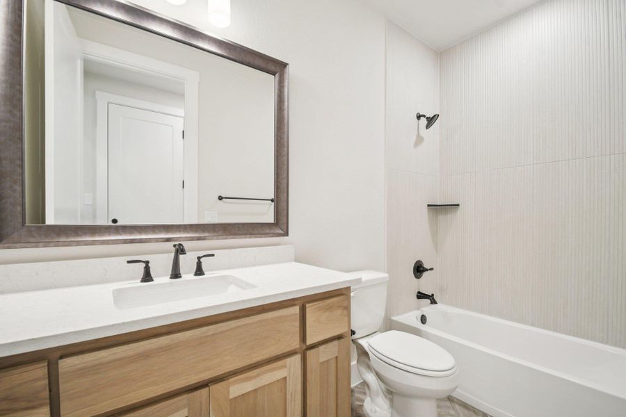 Full bath featuring shower / bathtub combination and vanity