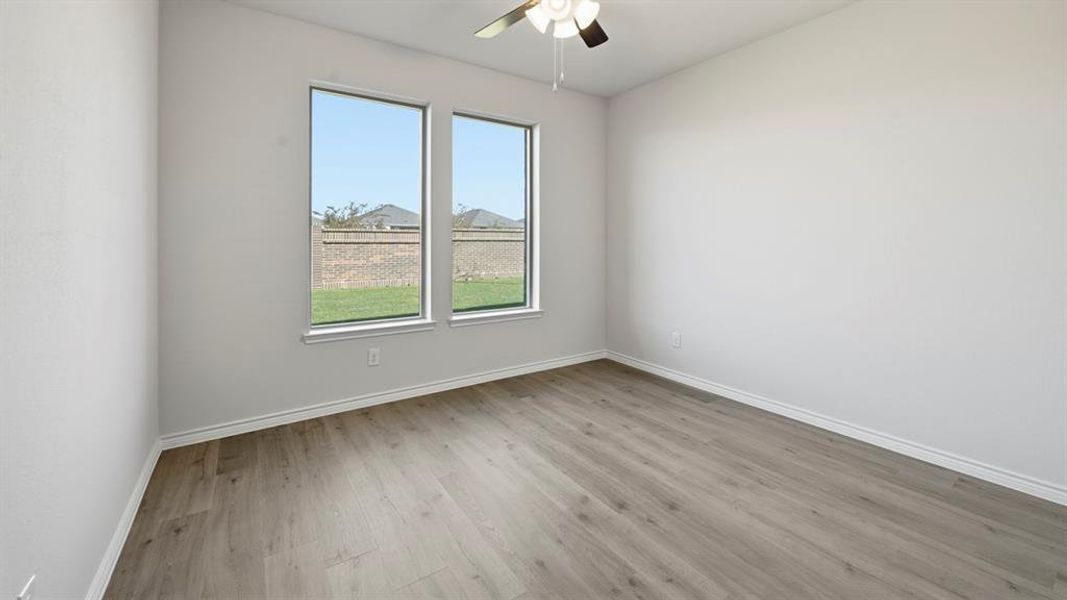 Unfurnished room featuring light wood-style floors and ceiling fan