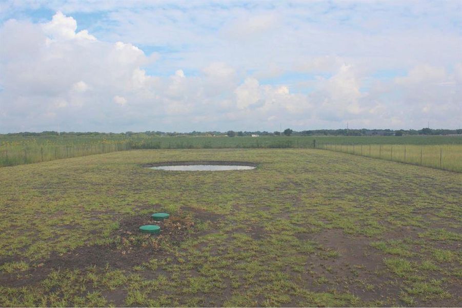 View of yard with a rural view and a pond. View of yard with a rural view and a pond.