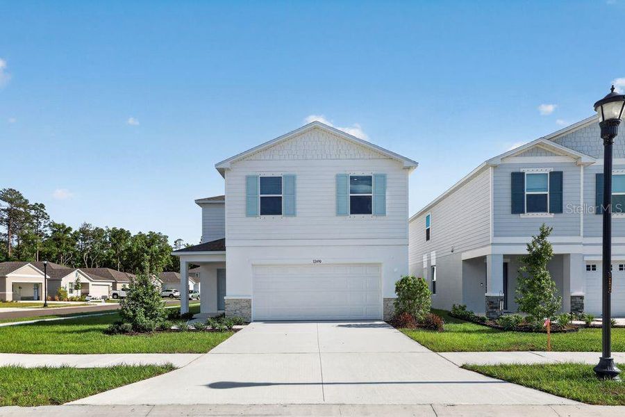 Front exterior of a new home in Palm Wind, Hudson, FL, highlighting curb appeal (Image 20).