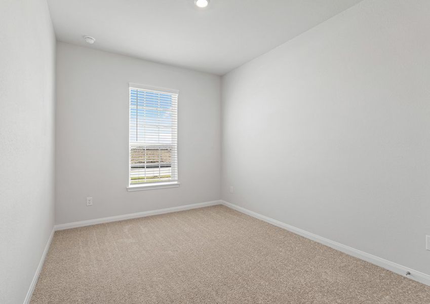 Spacious secondary bedroom with lush carpet