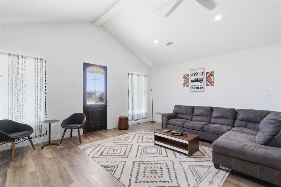 Living room with light wood-style flooring, a ceiling fan, and recessed lighting Living room with light wood-style flooring, a ceiling fan, and recessed lighting