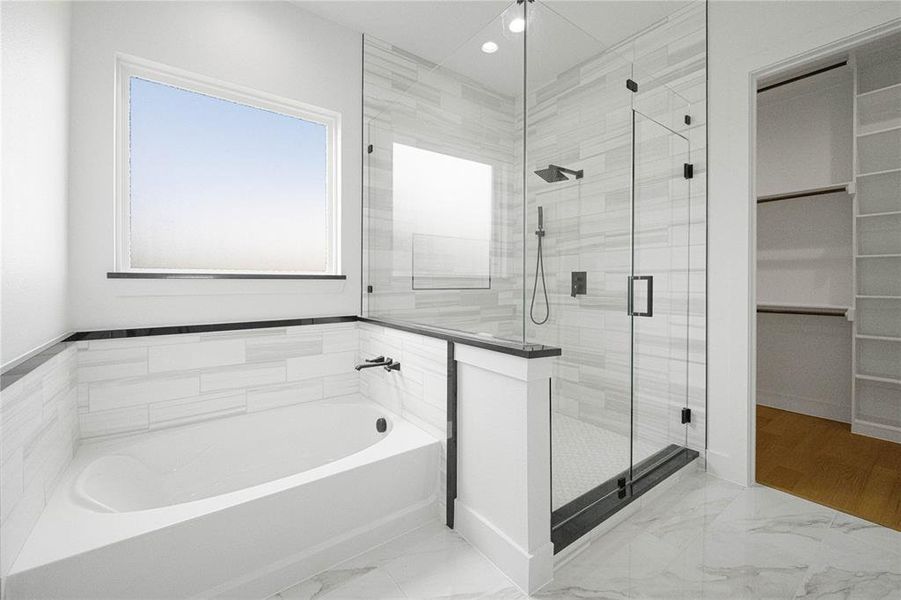 Bathroom with light marble finish flooring, a garden tub, a shower stall, a spacious closet, and recessed lighting