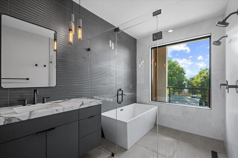 Bathroom with tile walls, vanity, a freestanding bath, light tile patterned floors, and a shower with shower door Bathroom with tile walls, vanity, a freestanding bath, light tile patterned floors, and a shower with shower door