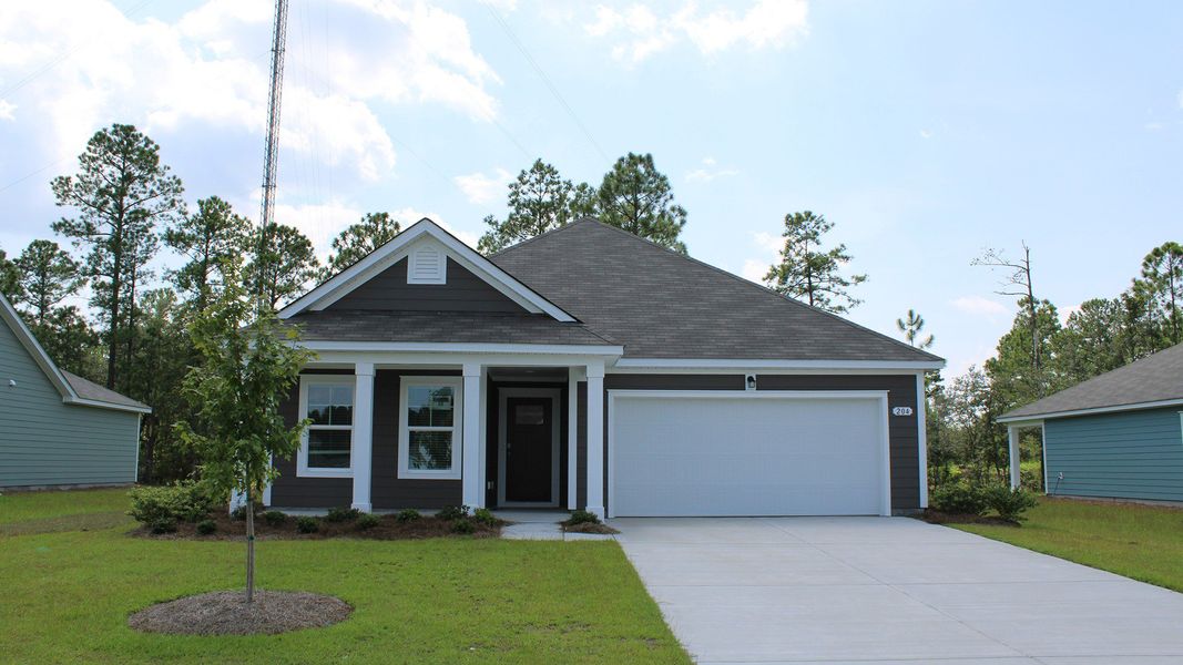 Front exterior of a new home in Rich Square at Brunswick Plantation, Ash, NC, highlighting curb appeal (Image 1).